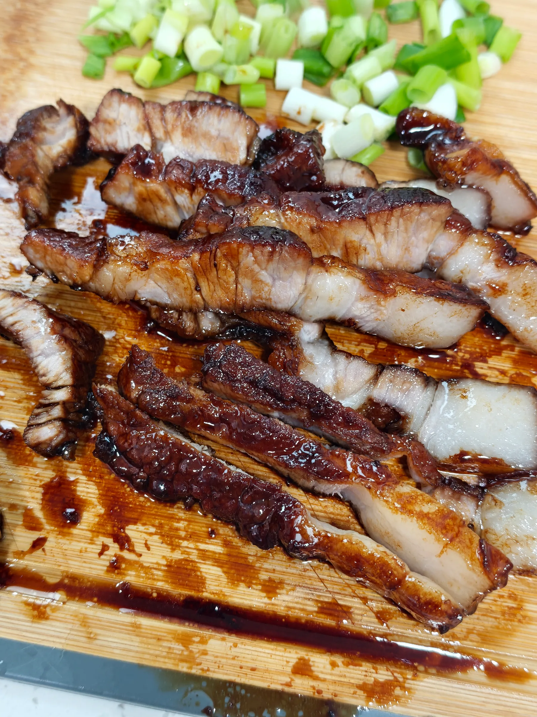 Sliced cola char siu on a board