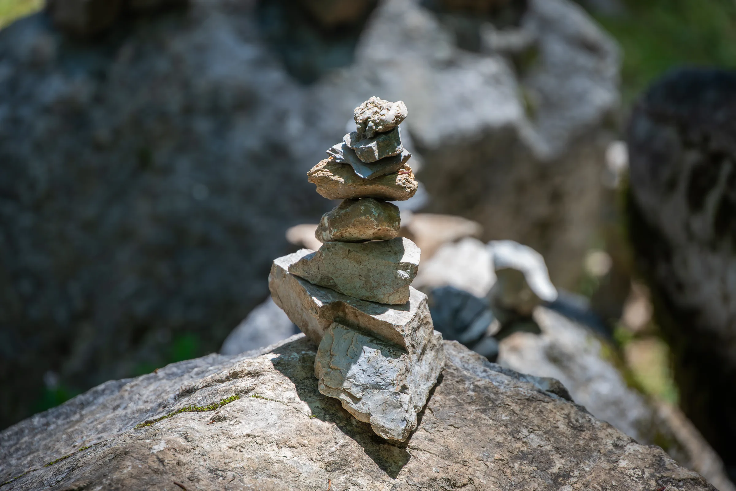 A small cairn of balanced stones on a rock